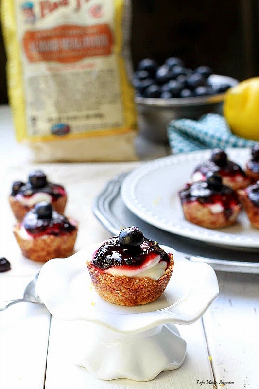 Mini Blueberry Lemon Almond Cheesecakes -- These easy gluten free mini blueberry cheesecakes are made with an almond flour crust, lightened up cheesecake filling and topped with a homemade blueberry sauce..jpg