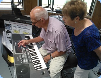 John Perkin setting-up a number on his Korg Pa900 whilst Diane Lyons observes closely.