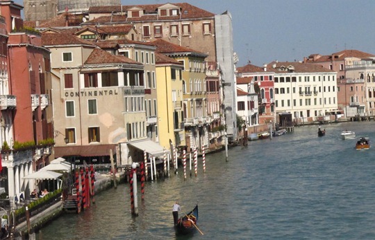 A Venetian gondola being paddled through the waterways of Venice