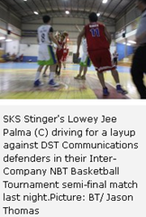 SKS Stinger's Lowey Jee Palma (C) driving for a layup against DST Communications defenders in their Inter-Company NBT Basketball Tournament semi-final match last night.Picture: BT/ Jason Thomas 