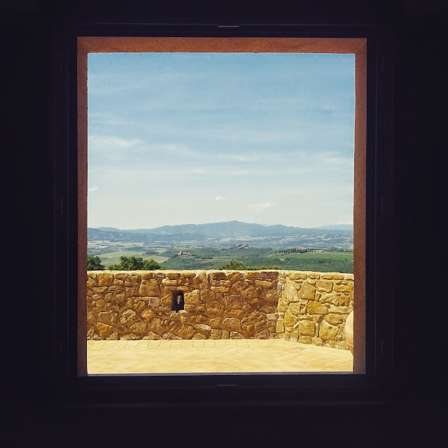 Tuscan landscape seen through the window of a Montalcino winery