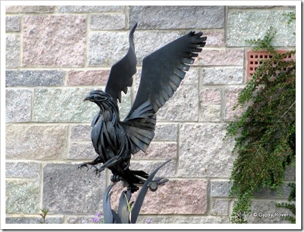 Rooster sculpture in a garden in Killin.