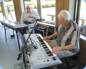 Peter Herrick playing the Yamaha Tyros 4 whilst Brian Teviotdale watches on with interest.