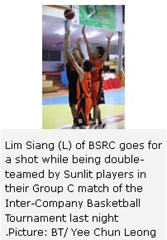 Lim Siang (L) of BSRC goes for a shot while being double-teamed by Sunlit players in their Group C match of the Inter-Company Basketball Tournament last night .Picture: BT/ Yee Chun Leong 