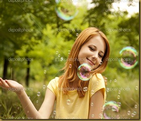 depositphotos_6025292-Redhead-girl-in-the-park-under-soap-bubble-rain.
