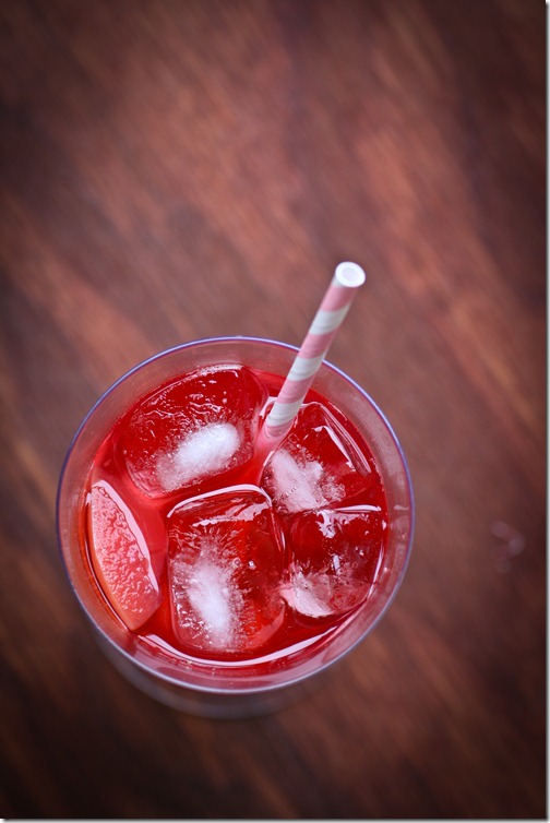 Red fruit kompot in a glass on a table