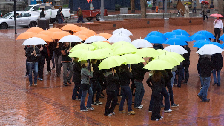 An umbrella dance troupe performs in Portland, Oregon.