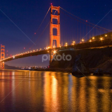 Golden Gate Bridge at dusk with reflections. by Gale Perry -  