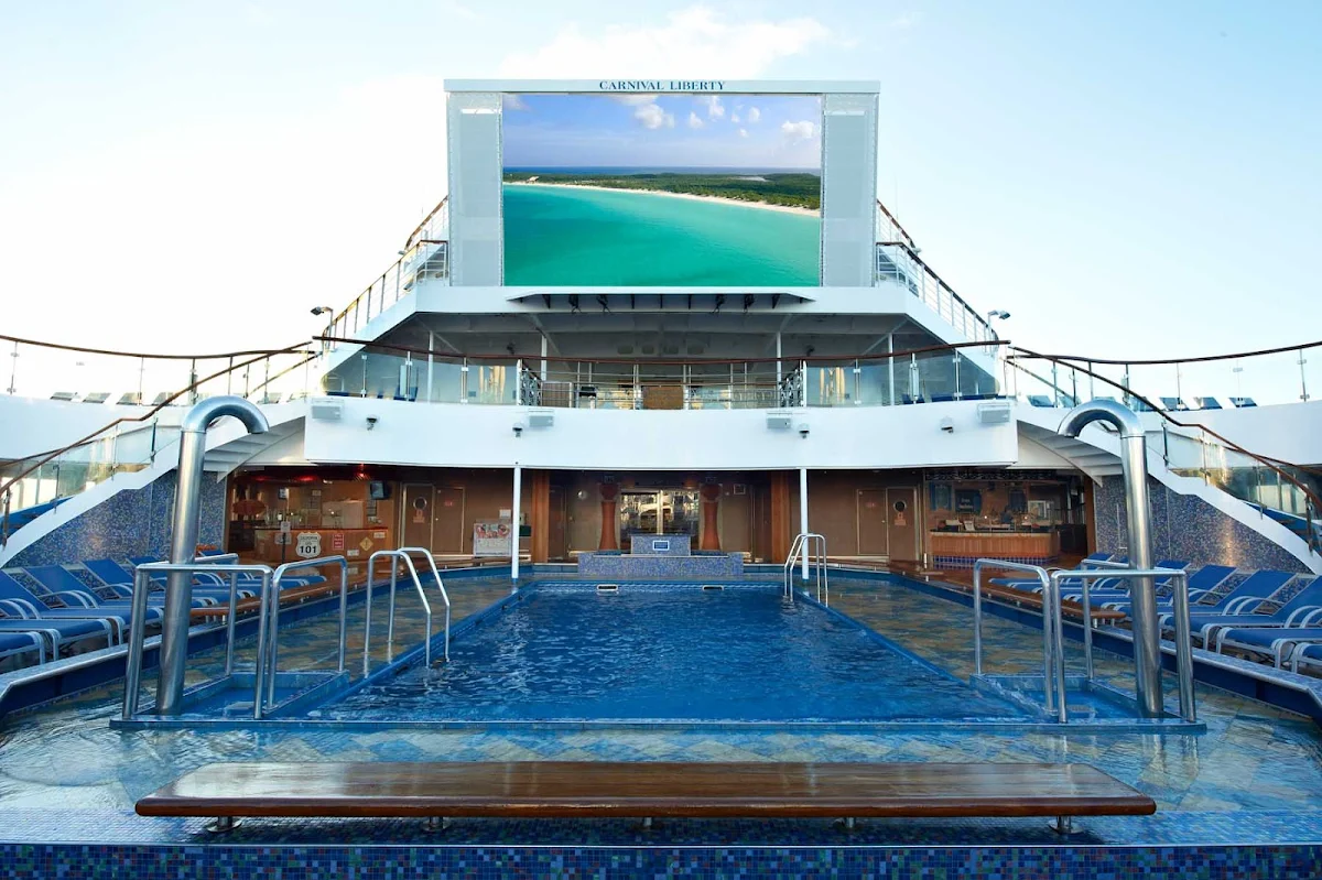 Carnival-Liberty-Seaside-Theatre - Settle into a hot tub or deck chair and watch movies, live sporting events and other entertainment on Seaside Theatre's jumbo screen, at the Tivoli pool on Carnival Liberty.