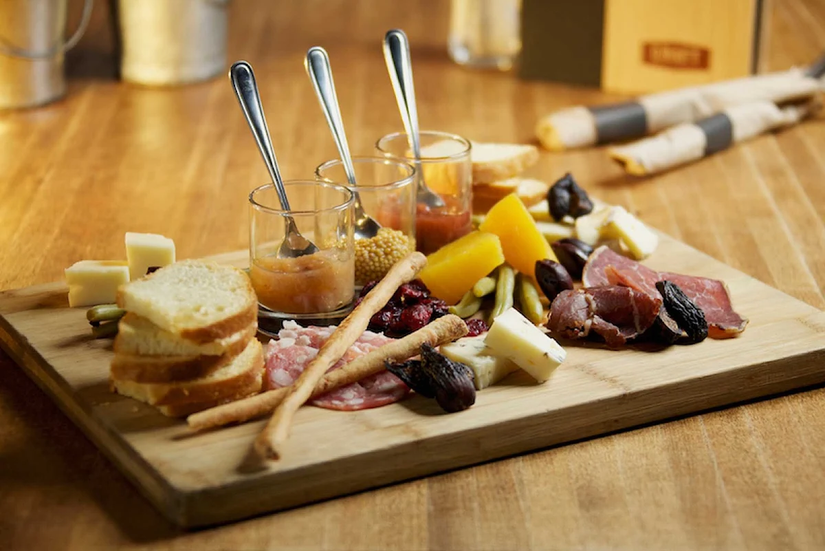 craft-beer-platter-Vancouver-British-Columbia - Locally cured meats from Two Rivers and assorted local cheese served with crostinis, preserves and mustard in Vancouver, British Columbia