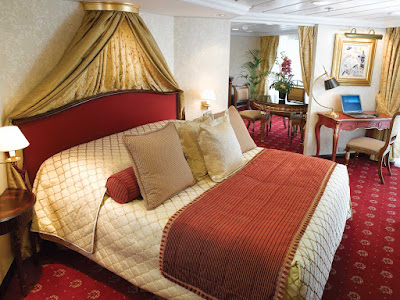 Spanning nearly 1,000 square feet, the Owner's Suite aboard Oceania Nautica includes a queen bed with 1,000-thread-count linens, private teak veranda for watching the passing landscapes, a second bathroom, two flat-screen TVs, laptop, iPad, 24-hour butler service, complimetary in-suite bar setup, priority embarkation and more. 