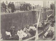 Omstanders bekijken het schutten van de Hollandia boot in de Oranjesluizen te Amsterdam