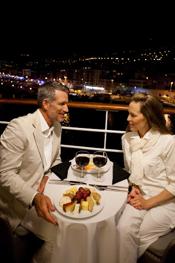 Azamara-Quest-balcony-dining-Nice-France - Enjoy a romantic dinner for two accompanied by the glittering lights of Nice, France, on an Azamara cruise.