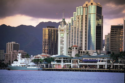 Aloha Tower Marketplace and downtown Honolulu skyline at dusk.
