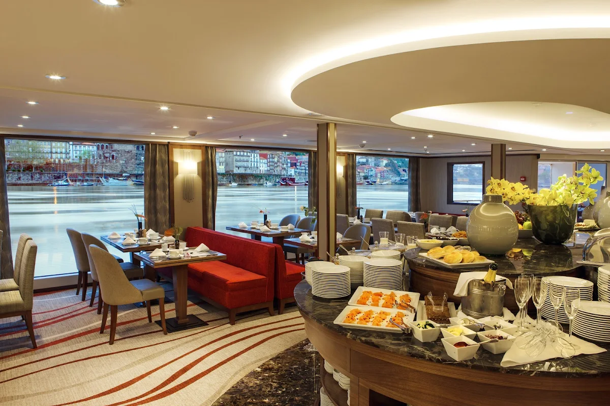 AmaVida-main-restaurant - Enjoy lunch and dinner in the company of new friends in the main restaurant aboard AmaVida as you sail the scenic Douro River in Portugal. 