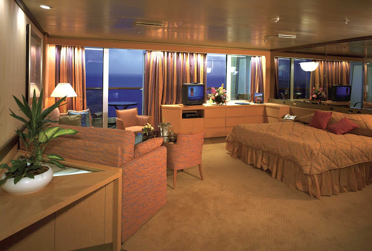 Relax in this cozy Neptune Suite aboard Holland America Line's Volendam.