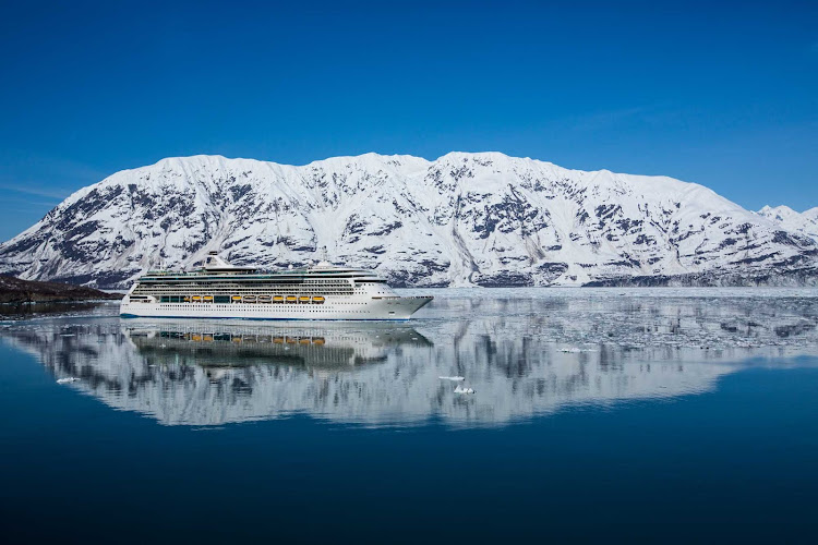 Pristine waters serve as a mirror as Radiance of the Seas glides past a glacier in Alaska.