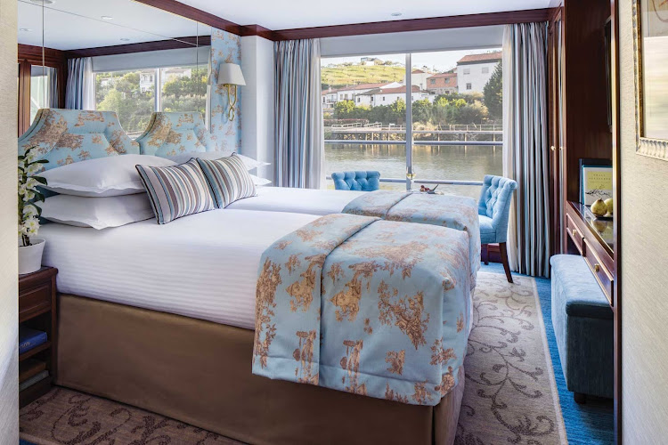 The comfortable staterooms aboard Uniworld's cruise ship Queen Isabel offer the luxury of space and uninterrupted views of the passing landscapes. 