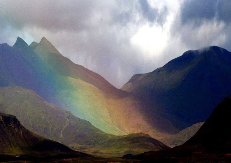 A rainbow rises out of a volcano in Iceland. 