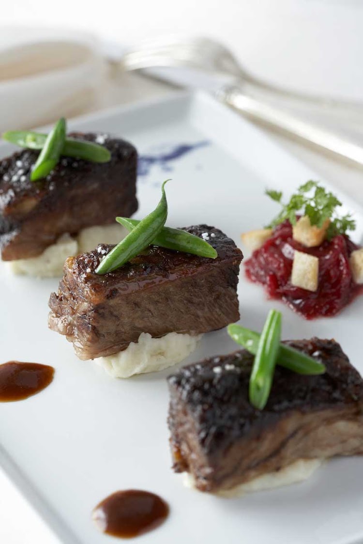 Tender braised short ribs with mashed potatoes, one of the elegantly presented dishes at Celebrity's Blu restaurant.