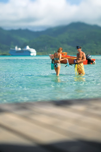 snorkelers_private_isle - Passengers on the Paul Gauguin can obtain snorkeling equipment at the marina at the beginning of their cruise and keep it throughout their voyage.