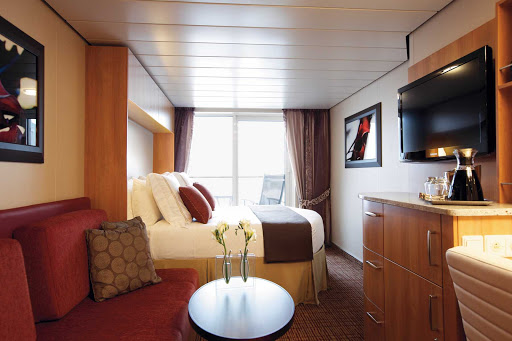 Tasteful décor and a flat-screen monitor adorn this Celebrity Silhouette stateroom.