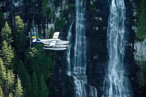 flight-harbour-air-Vancouver-British-Columbia - A Harbour Air Floatplane flies past waterfalls near Vancouver, British Columbia.