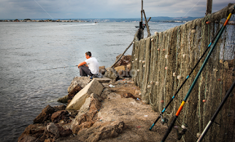 man fishing on the Meditteranean in the south of France by Judith Dueck -  