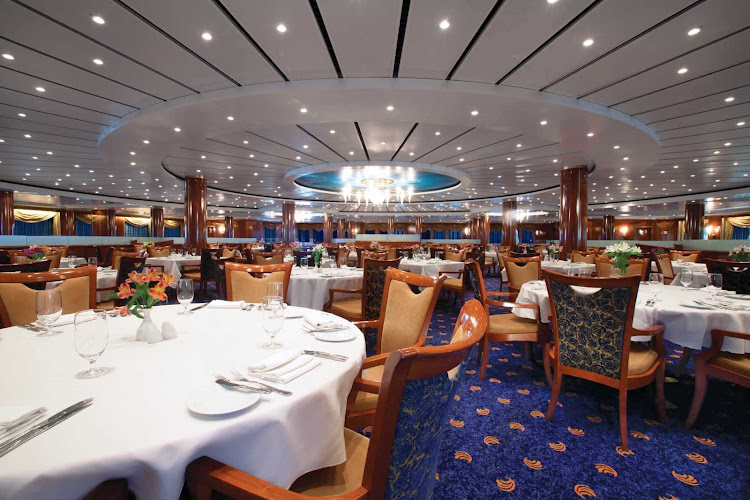Posh ambiance and award-winning gourmet fare await Norwegian Sun guests at the Seven Seas main dining room.
