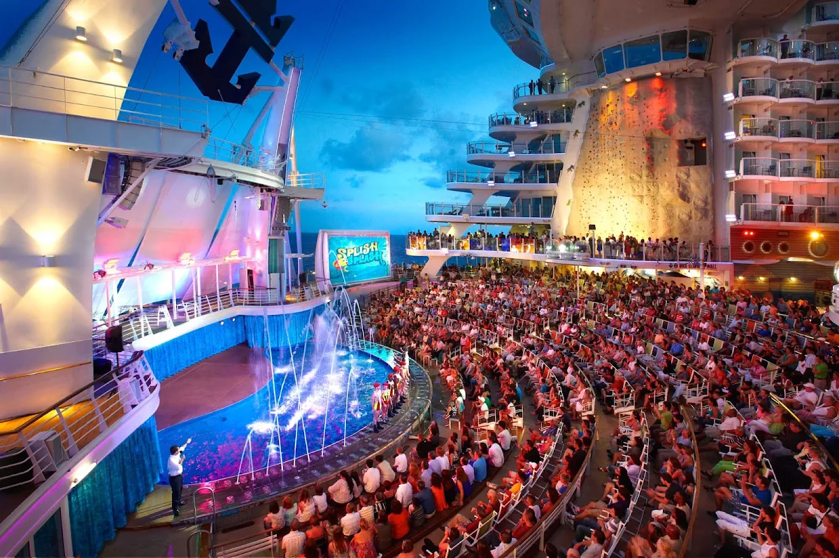 Aqua-Theater-Royal-Caribbean - By day, the Aqua Theater aboard Oasis of the Seas is a pool and lounge area. At night it turns into a theatrical venue offering eye-popping water shows and acrobatic performances with seating for 600.