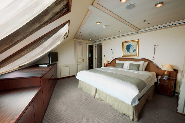 The Grand Suite aboard Silver Shadow has a spacious bedroom that features a queen size bed (or twin beds), sitting area and vanity table with hair dryer.