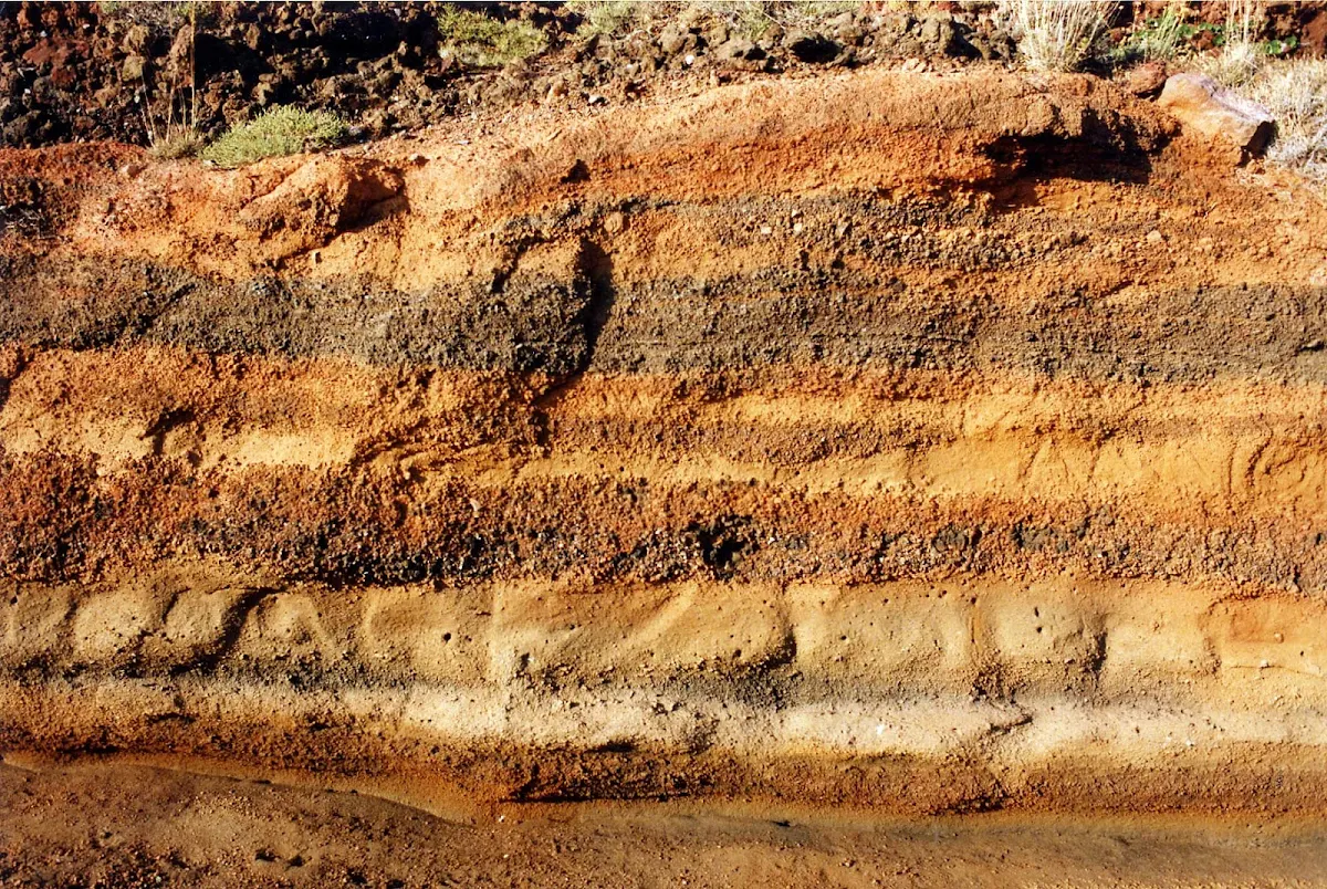 Santorini-caldera-pumice-1 - Walk on the narrow paths ringing the caldera of Santorini and you'll come across outcroppings of pumice — light and porous volcanic rock — that betrays the island's eruptive past. 
