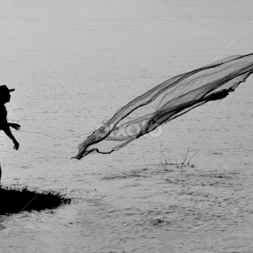 Throwhing his net by Dhruba Jyoti  Baruah - Black & White Abstract