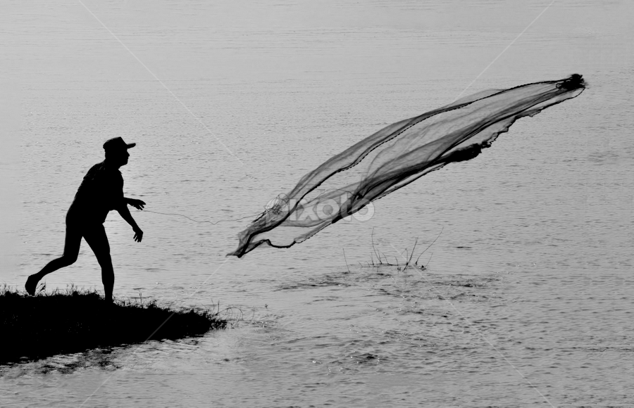 Throwhing his net by Dhruba Jyoti  Baruah - Black & White Abstract