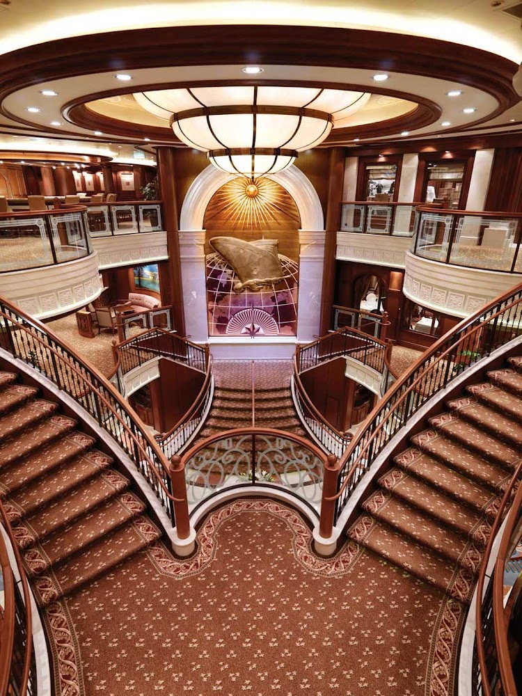 The Grand Lobby of Queen Victoria has beautiful triple-height ceilings, a double sweeping staircase and sculpted balconies.