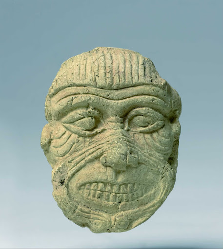 Plaque depicting the head of the giant demon Humbaba, the terrifying guardian of the Cedar Forest of Lebanon, identified by his wrinkled, grotesque face