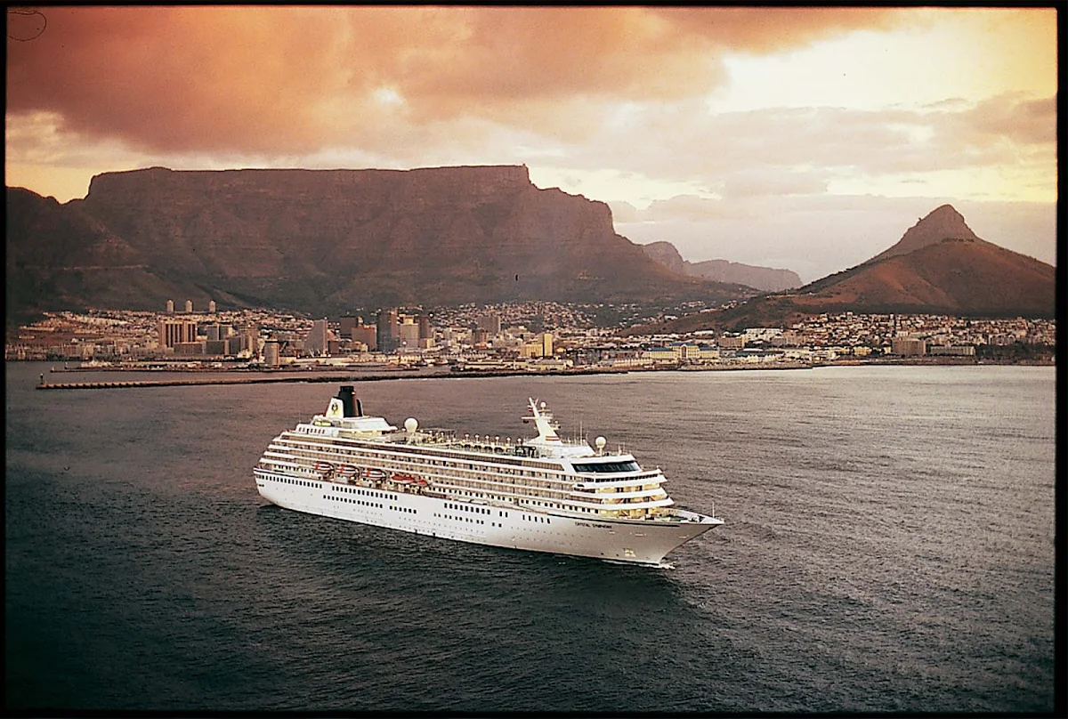 Crystal_Symphony_Capetown - Crystal Symphony sails off the coast of Cape Town, South Africa, at dusk.