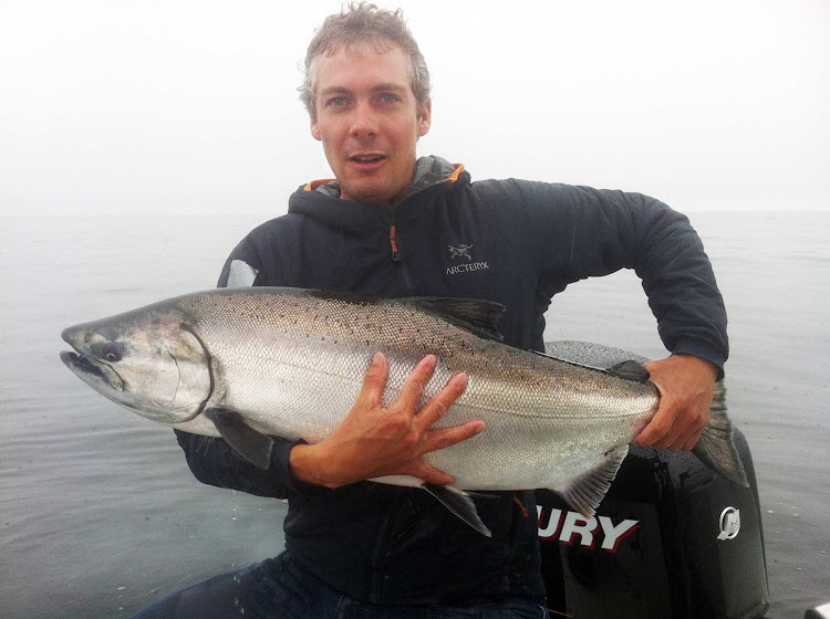 Nice catch! A local fisherman shows off a salmon he caught at Sewell's Marina in Vancouver, British Columbia.