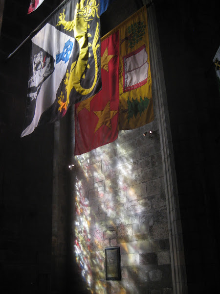 Light through stained glass and flags inside of St. Giles Cathedral in Edinburgh. It’s the midpoint of the “Royal Mile” on High Street.