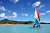 A Hobie Cat catamaran plies the waters off Jolly Beach, Antigua, in the Caribbean.