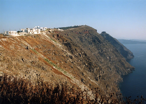 The caldera of Santorini with a view of the whitewashed houses of Fira perched atop sheer cliffs that plunge a thousand feet to the sea. An ocean-filled volcanic ring was left behind by a titanic eruption 3,500 years ago that devastated the region. It's one of the most stunning views in the world.