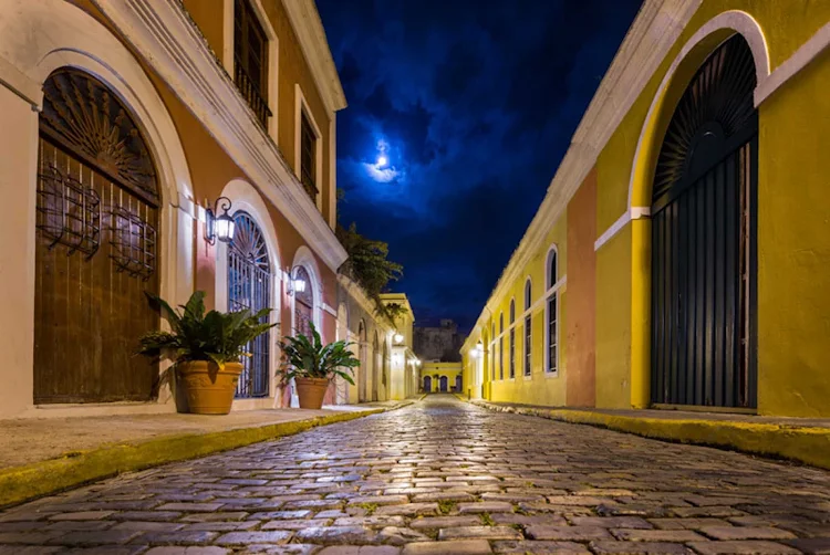 The glistening streets of Old San Juan bathed in moonlight.