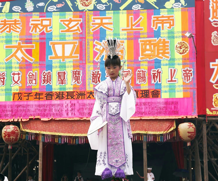 A girl performs at the Bun Festival in Hong Kong.