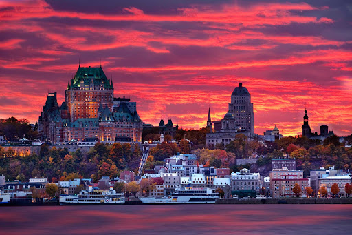 A dramatic sunrise behind the Quebec cityscape. 