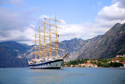 Royal Clipper arrives in Kotor, Montenegro, as part of a Mediterranean itinerary.  The ship carries just 227 guests and boasts 19,000 square feet of open deck and three swimming pools.