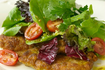 Veal Milanese topped with field greens and grape tomato salad