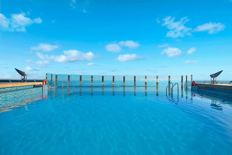 Soak up the sun and the scenery in MSC Divina's turquoise blue infinity pool during your cruise.