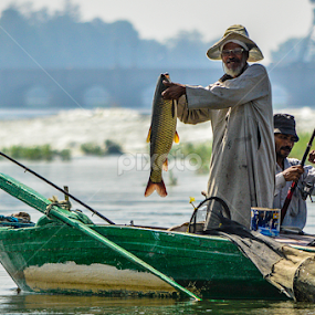The Uncle Mahmoud fishing by Morhaf Aljanee - People Professional People
