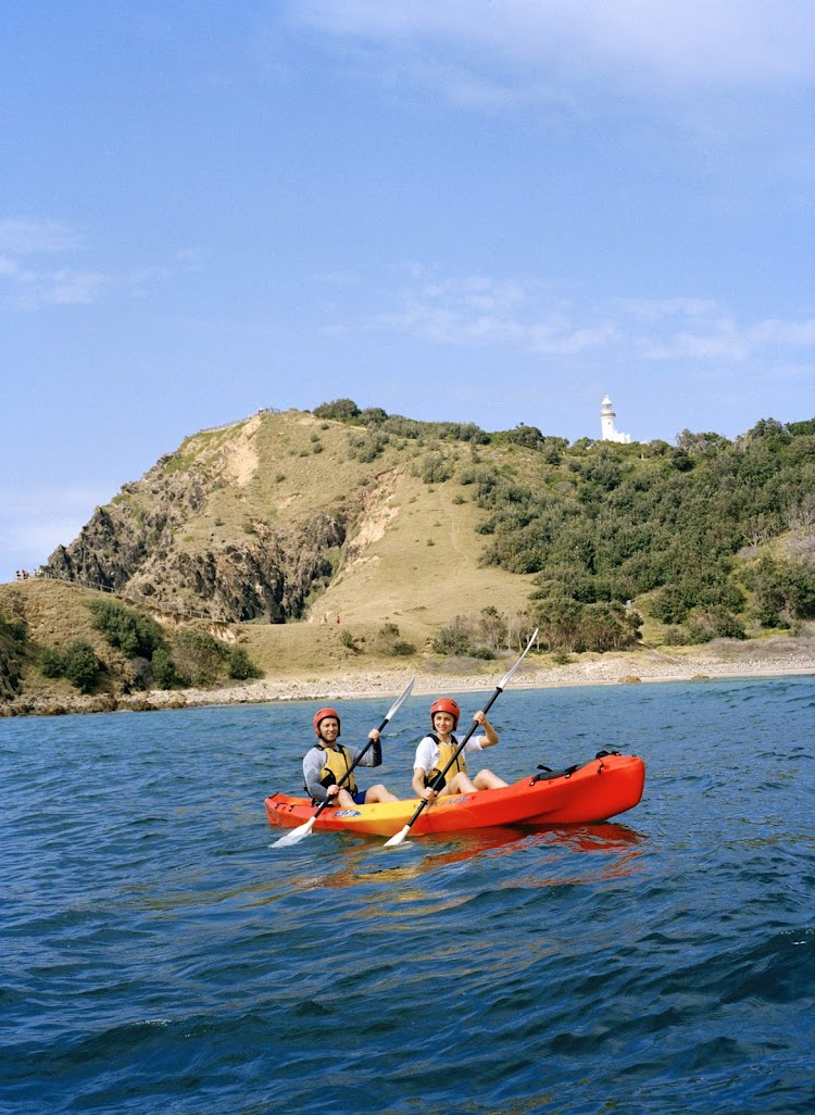 A couple kayaks around the front of the Cape Byron lighthouse in Byron Bay in the Northern Rivers/Tropical NSW region, Australia.