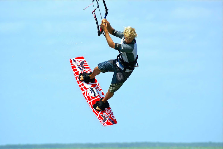 A kiteboarder catches some air along the coast of Mexico. Try it or just watch at Morph Kiteboarding in Tulum or El Cuyo, Yucatán. 